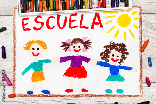Photo of  colorful drawing: Spanish word SCHOOL and happy children. First day at school.