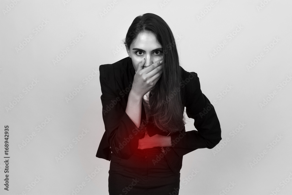 Portrait of a pretty young businesswoman with stomach issues she want to puke. Black and white with red accent Portrait of a pretty young businesswoman with stomach issues she want to puke. Black and white with red accent