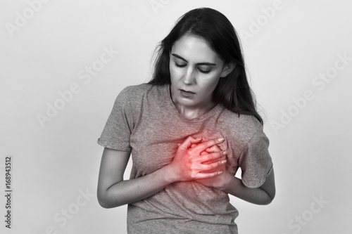 Beautiful female  with heart attack or broken heart. Black and white with red accent