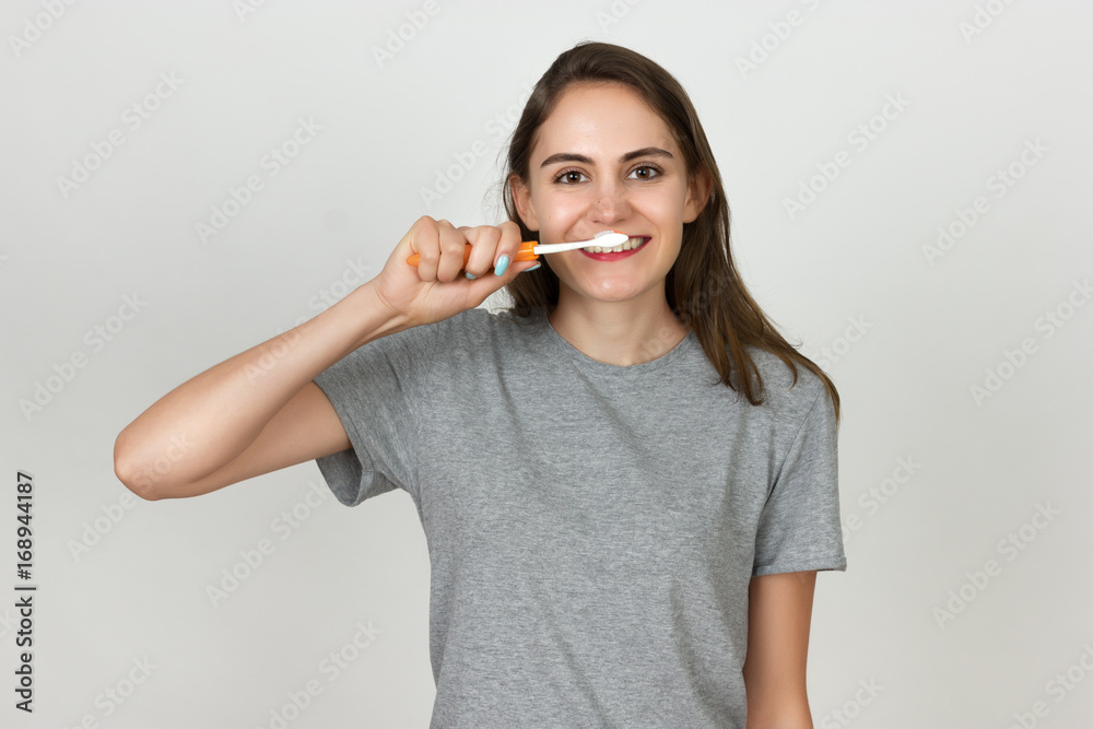 Beautiful young woman cleans teeth with toothbrush Beautiful young woman cleans teeth with toothbrush