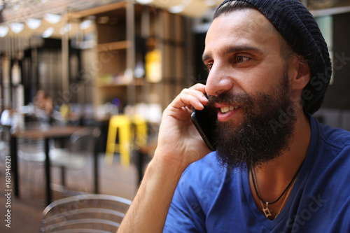 Man talking on phone in cafe