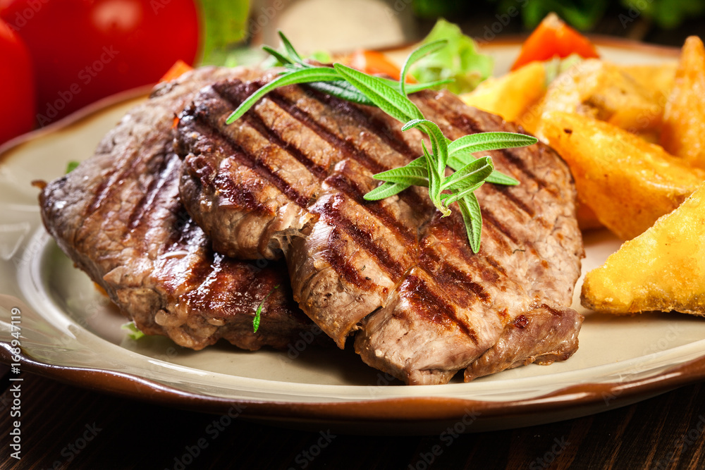 Succulent portions of grilled fillet mignon served with baked potatoes