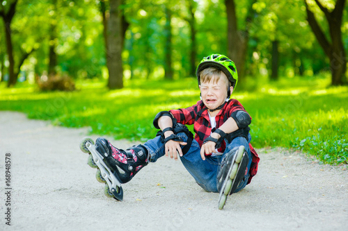 Boy crying falling on roller skates