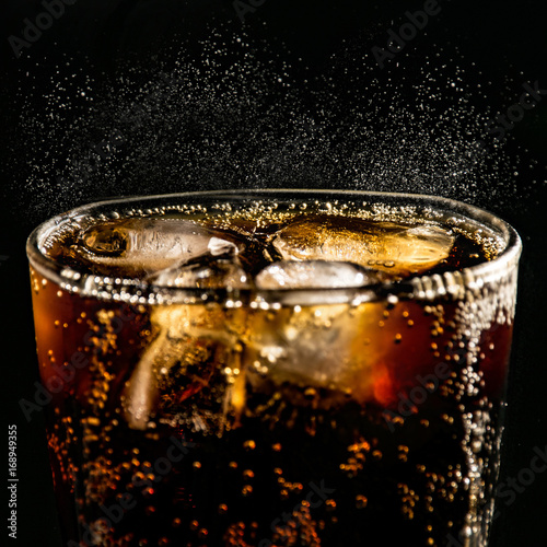 poured beverrage into a glass with ice,Cola drink is fizzy