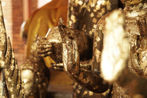 Antique Buddha Statues dated back to the 14th century covered in gold leaf adornment for good luck, good health, good virtue and prosperous at an ancient city of Phra Nakhon Si Ayutthaya, Thailand