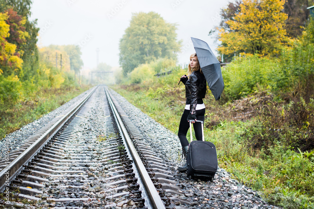 Girl, umbrella and rails in autumn Girl, umbrella and rails in autumn