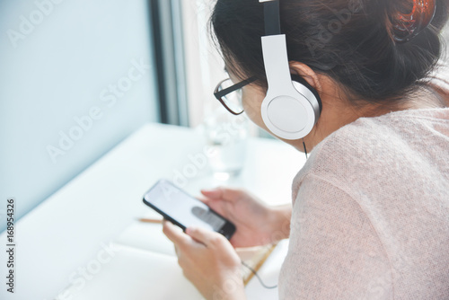 Asian woman listening to the music.