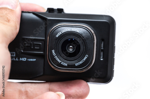 closeup digital camera action cam or dash cam show font lens in hand on white background photo