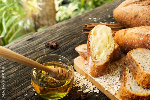 Freshly baked traditional Italian Cibatta bread cut in slices on a wooden table photo