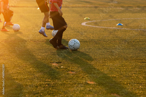 Youth training football in the football practice field. Sport concept.