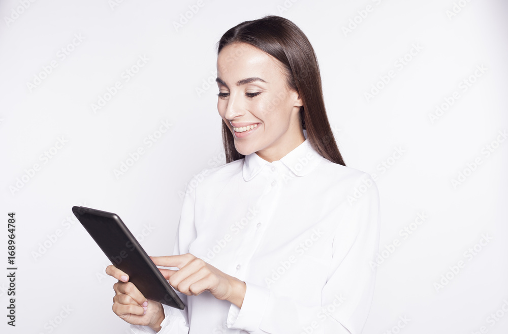 Beautiful brunette Business Woman using the digital tablet for work isolated on white background. Beautiful brunette Business Woman using the digital tablet for work isolated on white background.