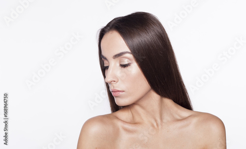 Beauty Woman face Portrait. Beautiful model Girl with Perfect Fresh Clean Skin brunette hair and Skin Care Concept. Isolated on a white background.