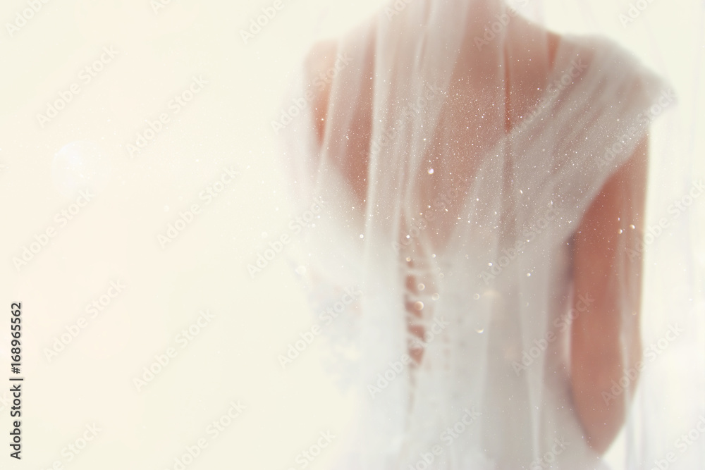 Fototapeta premium Dreamy abstract and blurry background of beautiful bride with wedding dress, from behind
