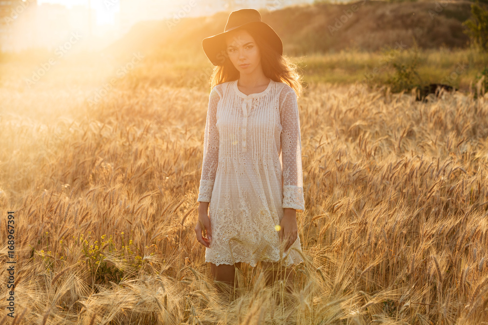 Beautiful young woman standing in the field Beautiful young woman standing in the field