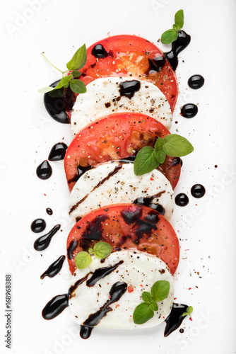 Fotografie Italian Caprese salad with Mozzarella Tomato Oregano Black Pepper and Balsamic V