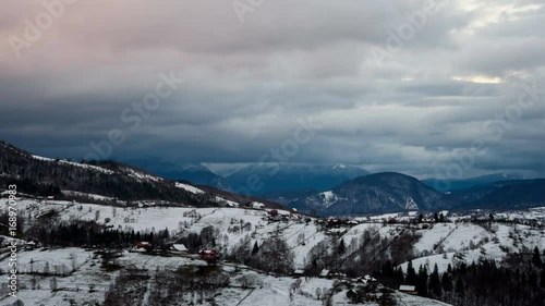 Wallpaper Mural Landscape of the Rucar-Bran Corridor in winter at sunset. Transylvania, Romania. 	Isolated houses in foreground and dynamic clouds over mountains in background. 4k timelapse. Torontodigital.ca