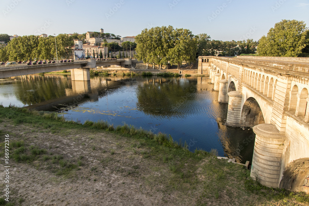 The Pont-canal de l'Orb in Beziers, a canal bridge part of the Canal du Midi in Southern France, with the city of Beziers and other bridge in the background. A world heritage site since 1996