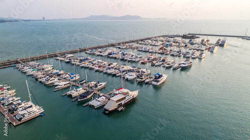 Pier speedboat. A marina lot. This is usually the most popular tourist attractions on the beach.Yacht and sailboat is moored at the quay.Aerial view by drone.Top view. © MAGNIFIER