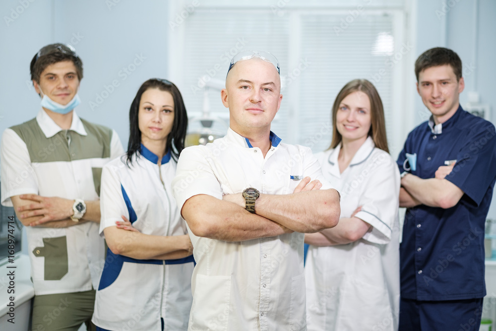 Group of dentists standing in their office and looking at camera. Group of dentists standing in their office and looking at camera.