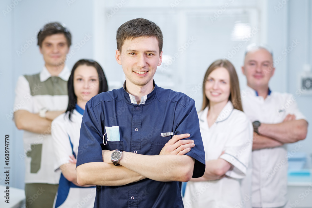 Group of dentists standing in their office and looking at camera. Group of dentists standing in their office and looking at camera.