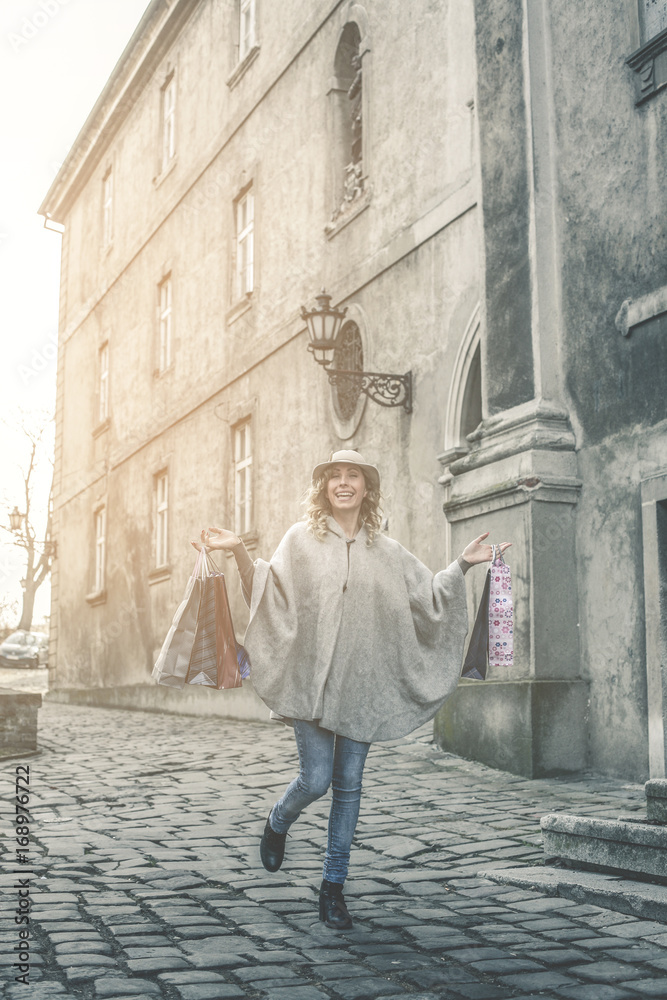 Happy woman in shopping. Young woman walking on the street