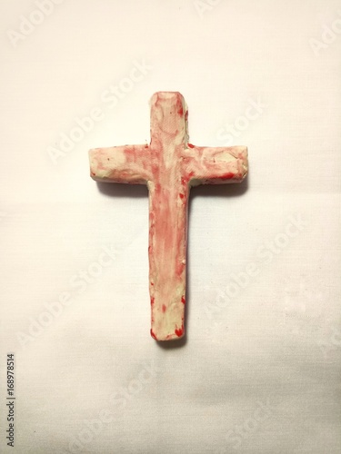 Cross of christ with blood color decoration, object made of kids plasticine photo