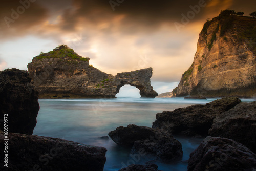 Rock in the ocean at Atuh beach on Nusa Penida island, Indonesia. sunrise