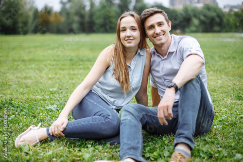 Happy young couple having a picnic outdoor on a summer day