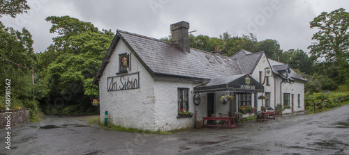 Pub Ireland. Lonely pub on a crossroads on a rainy day. Countryside. photo