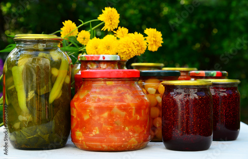 Photos Lot of homemade canned vegetables and jam in glass jars