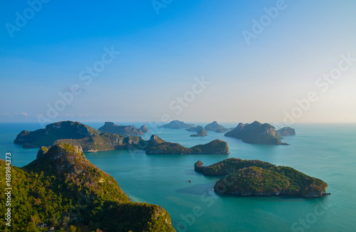 A high angle beautiful view of Angthong Islands National Park in Surat Thani, Thailand with reflection of bright and clear blue sky. Beautiful sea at gulf of Thailand at Angthong Islands.