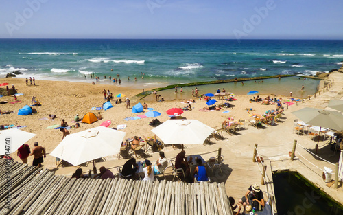 Azenhas do Mar, Portugal - circa August 2017: People enjoying the beach of Azenhas do Mar in Colares region (Sintra, Portugal) photo