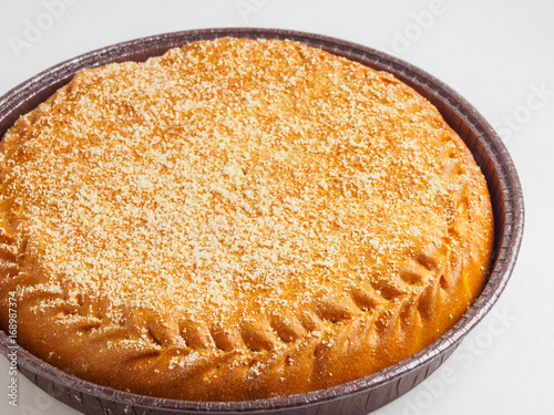round pie with filling on a table