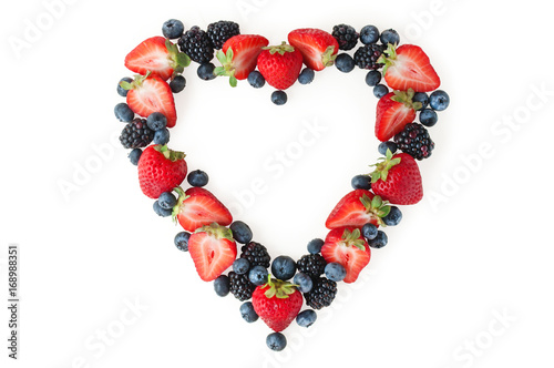 Heart of fresh strawberries, blueberries, blackberries isolated on white background. Top view, copy spase. Picture for a menu or a confectionery catalog.
