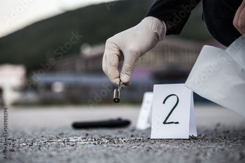 The crime scene, murder, investigation, sleeves shots serve as evidence, the investigation is done, the expert takes the capsule forceps and placed in the bag