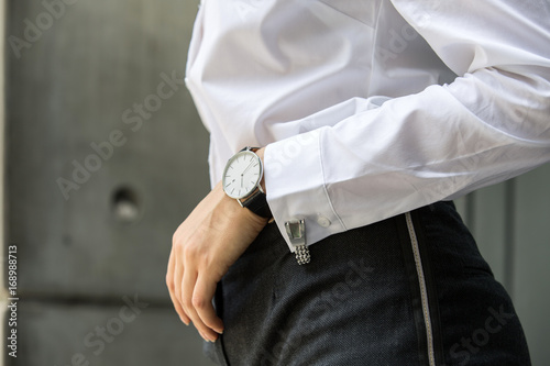 Image of woman hand at business suit wearing white shirt with cufflinks and watch resting her hand