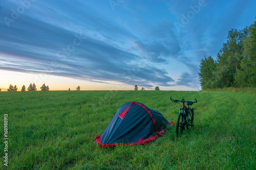 Tent and bike in the field.