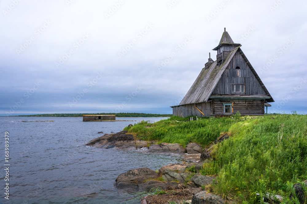 Beautiful landscape with a wooden chapel on the shore of Onega bay.