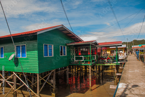 Traditional houses on stilts over the water. Sandakan, Borneo, Sabah, Malaysia photo
