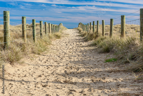 A sandy path between grassy dunes leads to the sea at Port Melbourne in Victoria, Australia © Adam Calaitzis
