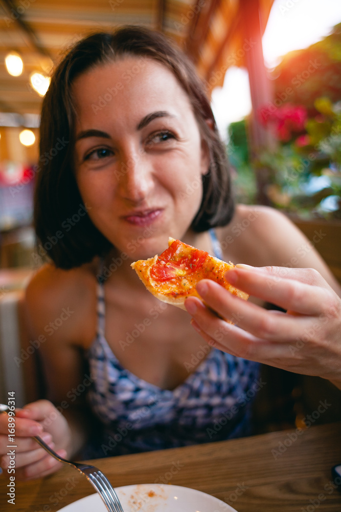 The girl is eating pizza.