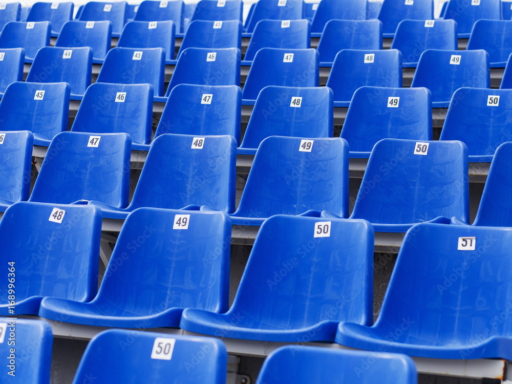 Naklejka premium Dark blue rows of seats on the stadium