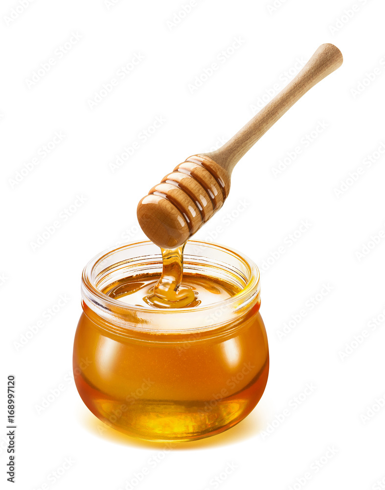 Honey dripping into jar isolated on white Honey dripping into jar isolated on white