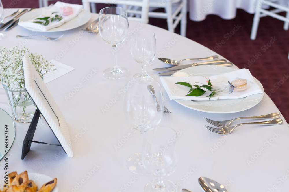 table setting with spoon, knife, plates and glass