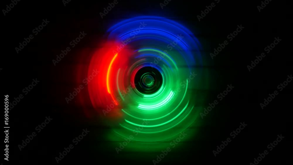Fidget spinner with red, green and blue LED lights spinning in the dark, top down view
Fidget spinner with red, green and blue LED lights spinning in the dark, top down view
