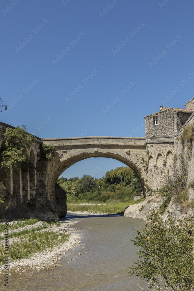 roman bridge and old town in vaison la romaine