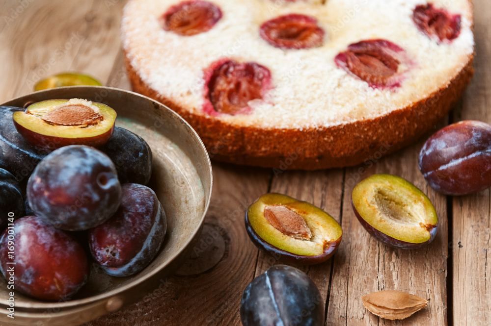 Pie with plum. In rustic style on a wooden surface Pie with plum. In rustic style on a wooden surface