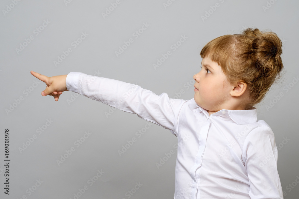 Cheerful little girl pointing away