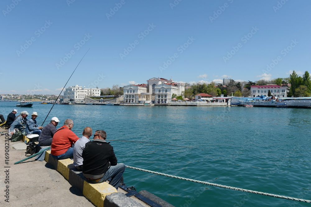 Fishermen on the embankment of Sevastopol.