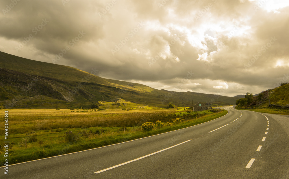 Fototapeta premium Landscape road in mountains under cloudy sky